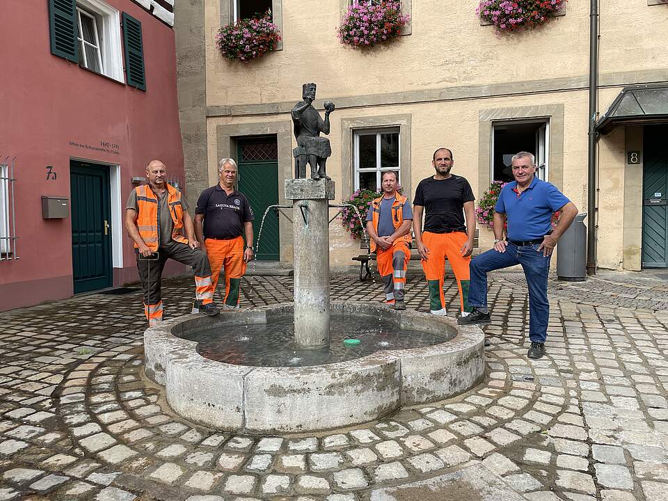 Bauhof-Team nimmt Konradsbrunnen in Betrieb Fünf Mitarbeiter des Forchheimer Bauhofs stehen um den Konradsbrunnen vor dem Verwaltungsgebäude in der St.-Martin-Straße.